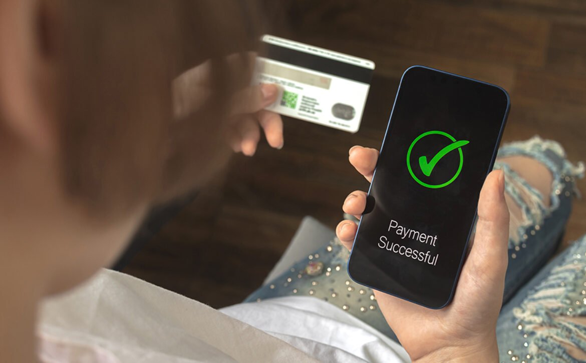 Financial transaction. Woman using mobile phone and hold credit card. Payment successful screen, shopping and e-commerce concept